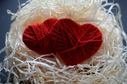 Knitted two eart on a raffia . Happy Valentine's Day.
