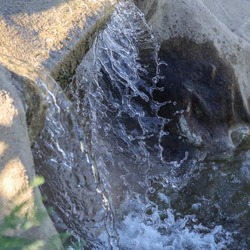 Waterfall frozen at high shutter speed with visible water droplets