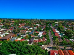 Panoramic Aerial Drone view of Suburban Sydney housing, roof tops, the streets and the parks