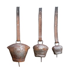 front view closeup of metal rusted cowbells with leather collar isolated on white background