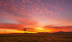 Beautiful sunset over Melville near Maitland in the Hunter Valley. With rustic old  windmill in the foreground. Melville ,N.S.W. Australia.