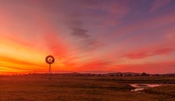 Beautiful sunset over Melville near Maitland in the Hunter Valley. With rustic old  windmill in the foreground. Melville ,N.S.W. Australia.