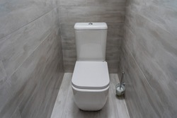 Stylish toilet in modern grey bathroom