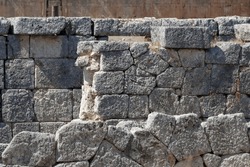 Ruins of a stone wall. Greek city of Tlos, Turkey. Lycian rock tombs