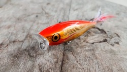 red orange popper top water fishing bait