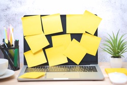 Yellow post note paper, memo paper on a screen laptop computer. scheduled for job or short note for work concept, minimal office desk.
