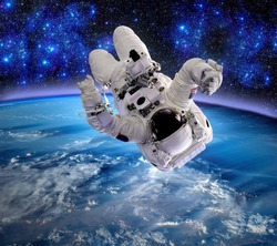Astronaut upside down spaceman relax space suit stars. Elements of this image furnished by NASA.