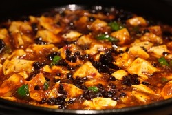 extreme close up Mapo tofu in plate. Popular Chinese dish from Sichuan. Tofu set in a spicy sauce