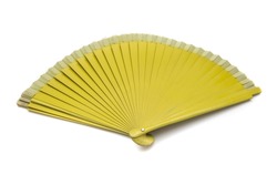 Mustard colored fan, isolated on white background. A fan is a fashion accessory designed so that with a rhythmic and variable movement of the wrist, air can be moved and cooling facilitated.