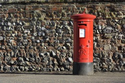 Red English pillar box or post box.
