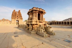 Unbelievable stone chariot in the courtyard of Vittala Temple at sunset in Hampi, Karnataka, India