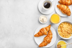 Delicious breakfast with fresh croissants and black coffee on white background. Top view. Copy space.