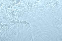 Fresh water background. Light blue pattern with natural rippled water texture. Top view with copy space. Cosmetic water surface background. Moisturizing, hydration concept