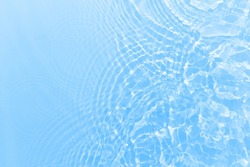 Fresh water background. Bright blue pattern with natural rippled water texture. Clear drinking water. Top view with copy space.