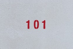 RED Number 101 on the white wall. Spray paint. 