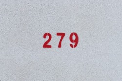 RED Number 279 on the white wall. Spray paint. 