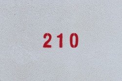 RED Number 210 on the white wall. Spray paint. 