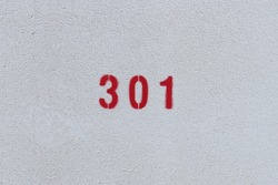 RED Number 301 on the white wall. Spray paint. 
