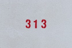 RED Number 313 on the white wall. Spray paint. 