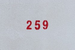 RED Number 259 on the white wall. Spray paint. 
