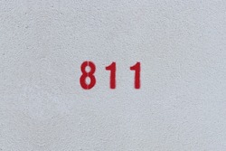 RED Number 811 on the white wall. Spray paint.