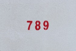 RED Number 789 on the white wall. Spray paint.