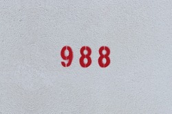 RED Number 988 on the white wall. Spray paint.