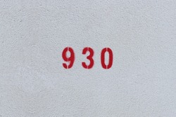 RED Number 930 on the white wall. Spray paint.