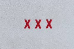 RED X X X on the white wall. Spray paint.