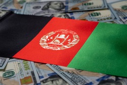 Afghanistan flag with US dollars as background. Concept for investors, soft focus