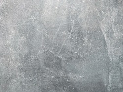 Neutral gray background. Scratched concrete with smears of streaks.