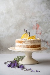 Lemon cake on cake stand,Light dessert with lemon.Naked cake with mascarpone, lemon and whipped cream