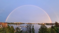 Beautiful rainbow in Stockholm, Sweden. Rainbow over the lake Mälaren. Lovely water view in Stockholm.