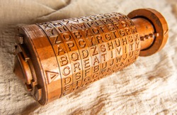 Opened brass cryptex invented by Leonardo da Vinci from the book da vinci code. Cryptographic equipment printed on a 3D printer. Word creativity as password set by letters rings.