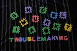 Word Troublemaking on black background. Troublemaking means Causing trouble.