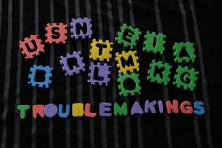 Word Troublemakings on black background. Troublemaking means Causing trouble.