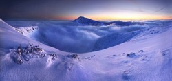 Winter mountain landscape with fog in the Giant Mountains on the Polish and Czech border - Karkonosze National Park.
Scenic view of over snow covered Giant mountains