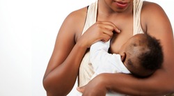 African young  Mother breastfeeding her little baby in her arms.