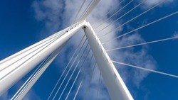 Photo taken of the top spire of the Northern Spire bridge in Sunderland, showing cables and the white metal structure against the blue sky.