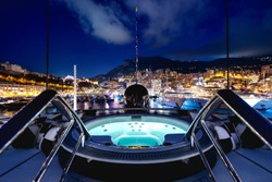 A beautiful shot of a night view full of lights and adventure from a private yacht