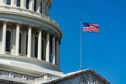 A low angle closeup of The United States Capitol under the sunlight and a blue sky in Washington DC