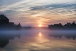 A beautiful shot of the sunrise with the morning mist on the Lake Jarun located in Zagreb, Croatia