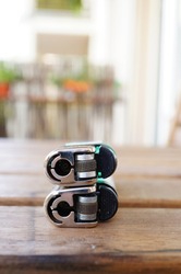 A vertical selective focus clsoeup of two stack of lighters on a wooden table