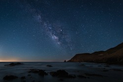 A scenic night landscape with Milky Way on the coast of the Escullos in Cabo de Gata in Spain