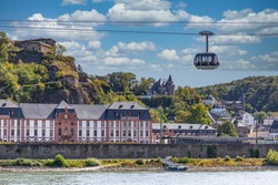 A gondola of the cable car across the river Rhine in Koblenz, Germany, with the fortress and ancient buildings in the background