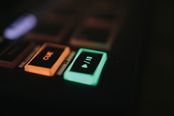 A closeup shot of the sound effect buttons with colorful lights in the darkness