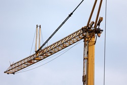 A construction crane on a blue sky background