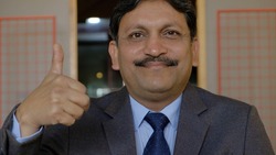 A closeup shot of an Indian businessman showing OK