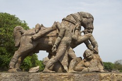 A rock sculpture of horse crushing a soldier during war at Sun Temple, Konark, Orissa, India