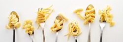 Various types of spaghetti, noodles, and pasta on the forks and spoons in the white background